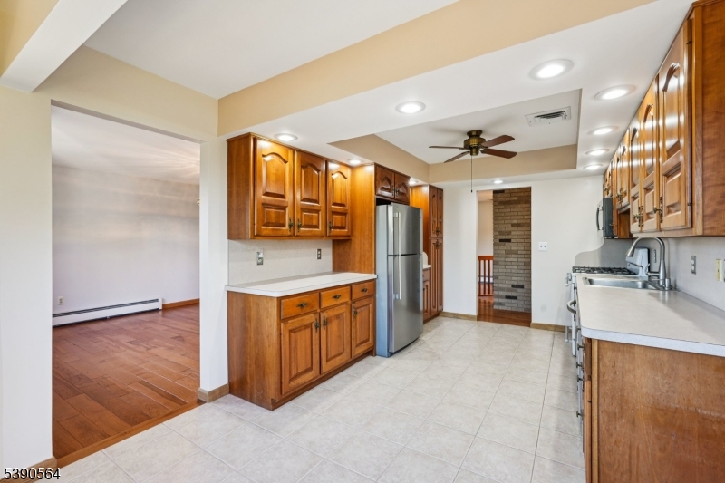 8 Cambridge Road Totowa, NJ 07512 - Photo 11 of 35 a kitchen with stainless steel appliances granite countertop a sink and a refrigerator