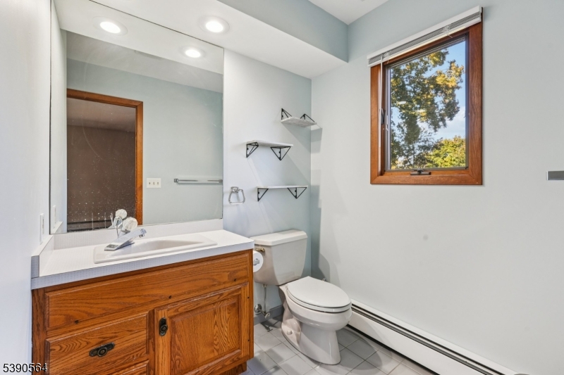 8 Cambridge Road Totowa, NJ 07512 - Photo 15 of 35 a bathroom with a sink a toilet and shower
