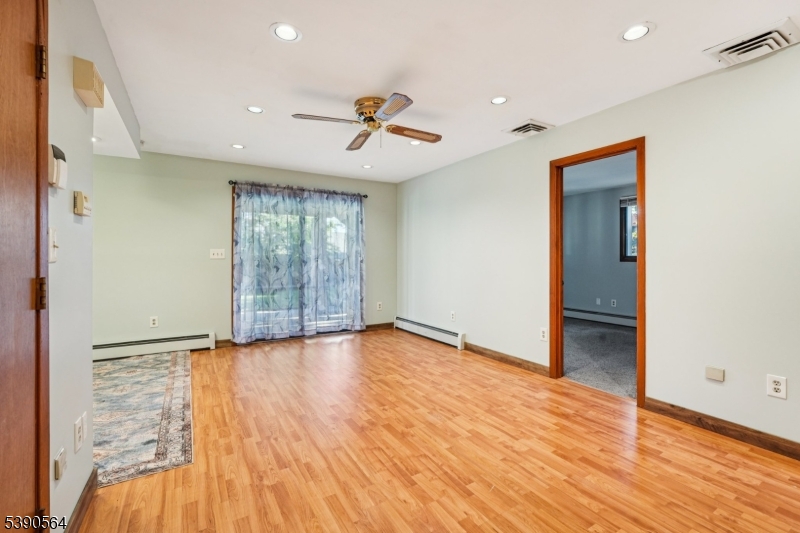 8 Cambridge Road Totowa, NJ 07512 - Photo 21 of 35 an empty room with wooden floor and windows