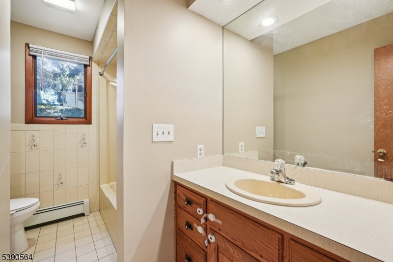 8 Cambridge Road Totowa, NJ 07512 - Photo 26 of 35 a bathroom with a sink and a mirror