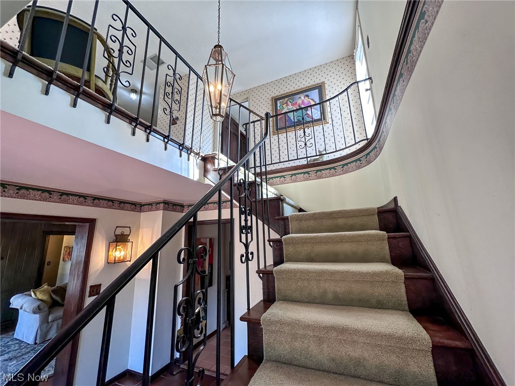 11911 County Line Road Chesterland, OH 44026 - Photo 4 of 49 Stairs featuring an inviting chandelier and a high ceiling