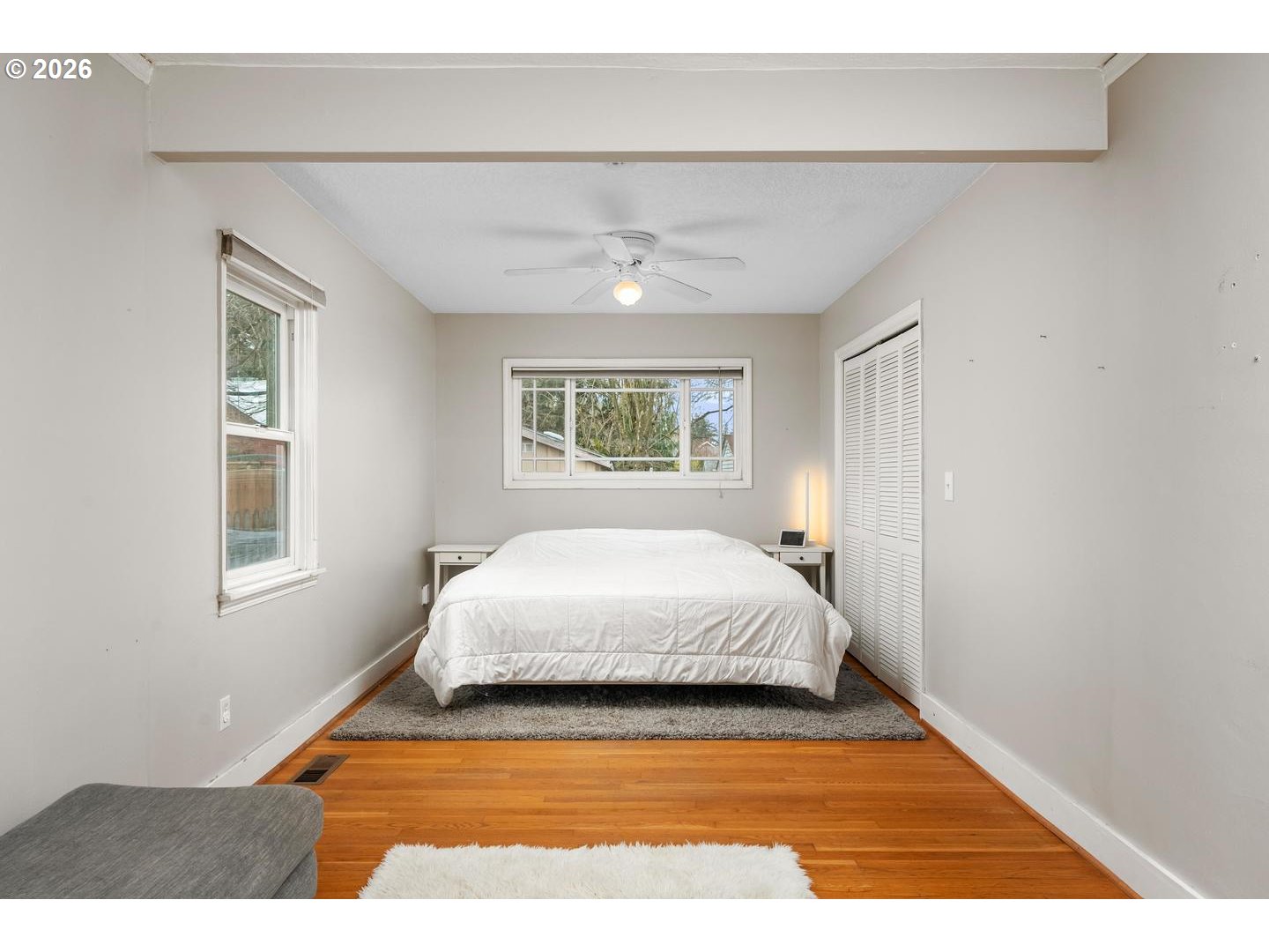 3825 Northeast 63rd Avenue Portland, OR 97213 - Photo 16 of 43 a spacious bedroom with a large bed and a window