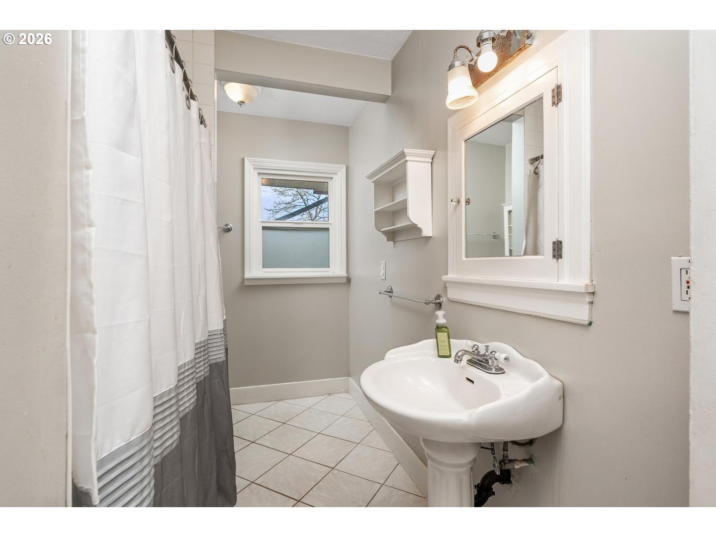 3825 Northeast 63rd Avenue Portland, OR 97213 - Photo 19 of 43 a bathroom with a sink a mirror and a toilet