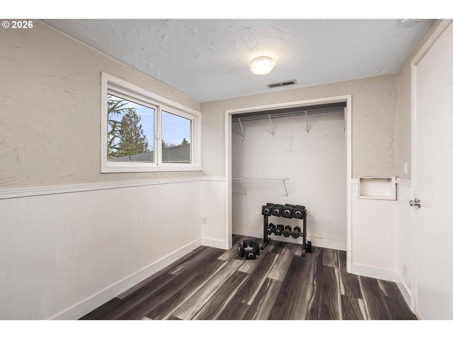 3825 Northeast 63rd Avenue Portland, OR 97213 - Photo 26 of 43 a bedroom with a bed and a painting on the wall