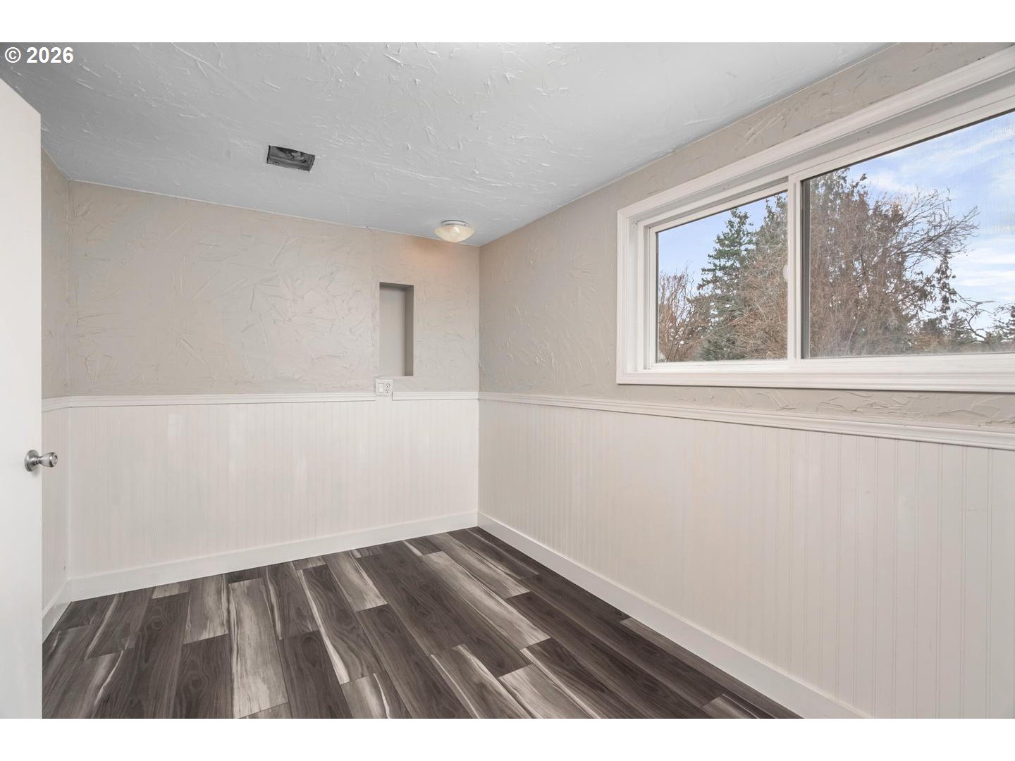 3825 Northeast 63rd Avenue Portland, OR 97213 - Photo 27 of 43 a view of an empty room with wooden floor and a window