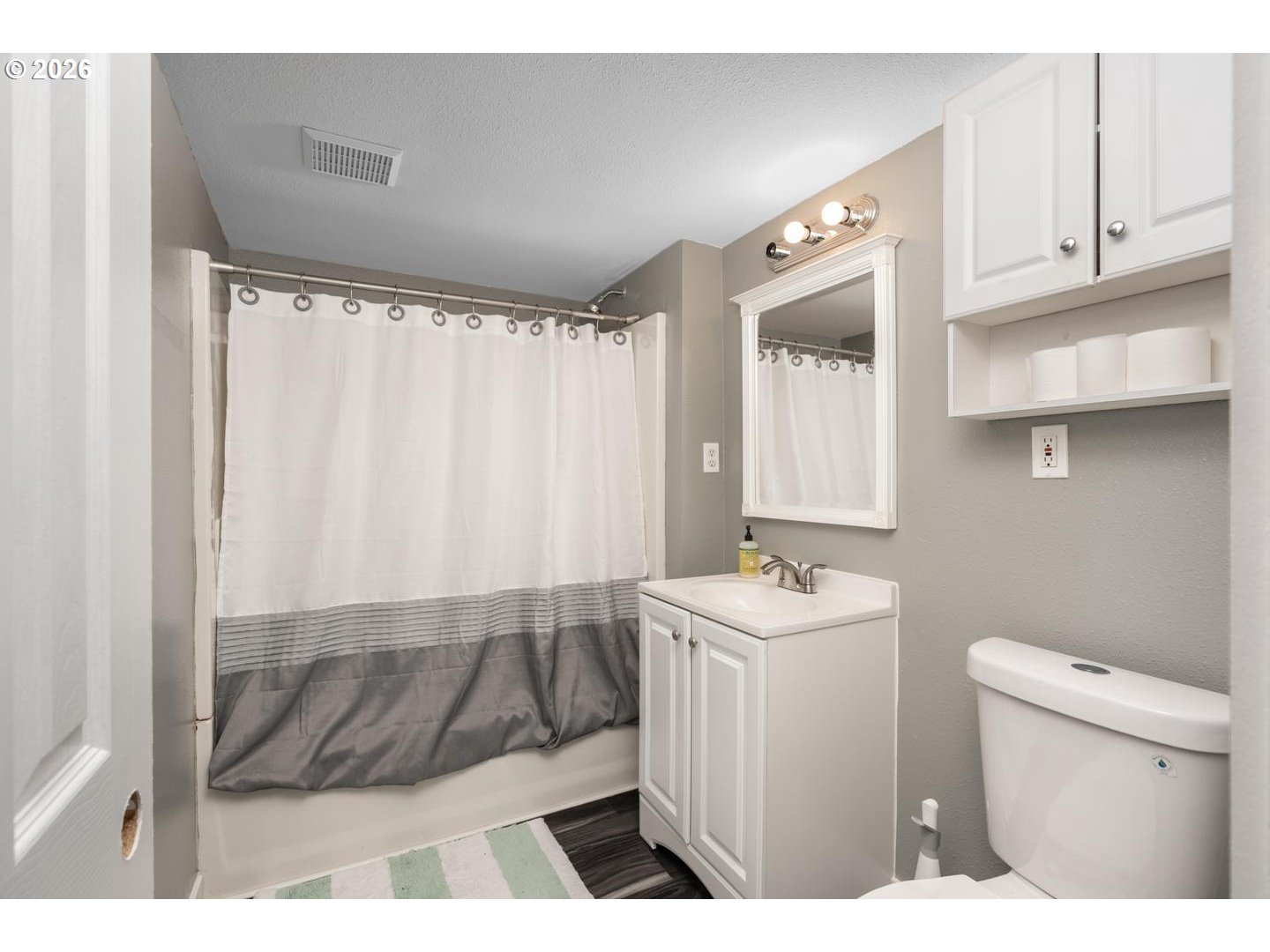 3825 Northeast 63rd Avenue Portland, OR 97213 - Photo 32 of 43 a bathroom with a sink a toilet a mirror and vanity