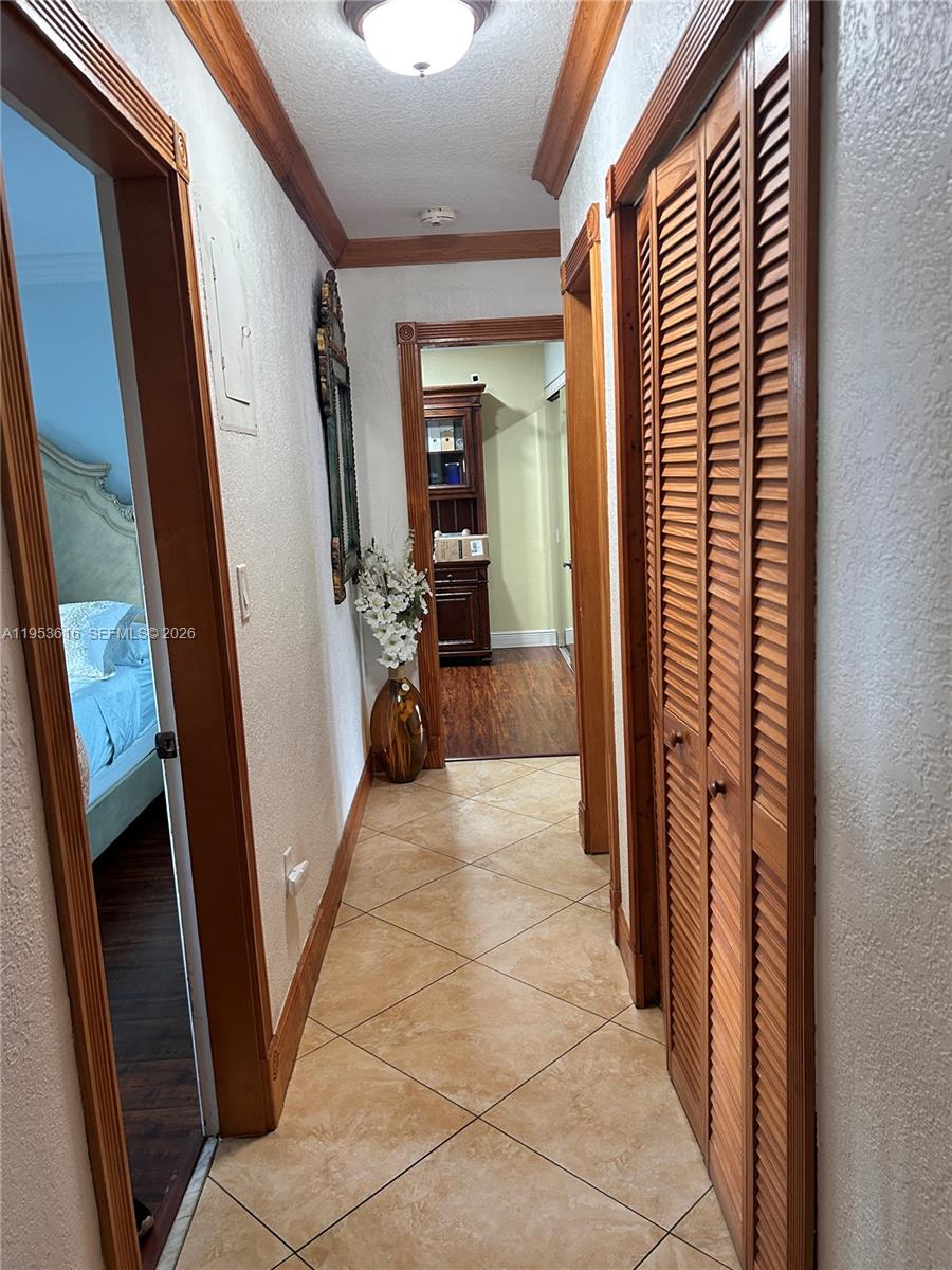 2600 Southwest 126th Avenue Miami, FL 33175 - Photo 12 of 23 a view of a hallway to a livingroom with furniture and front door