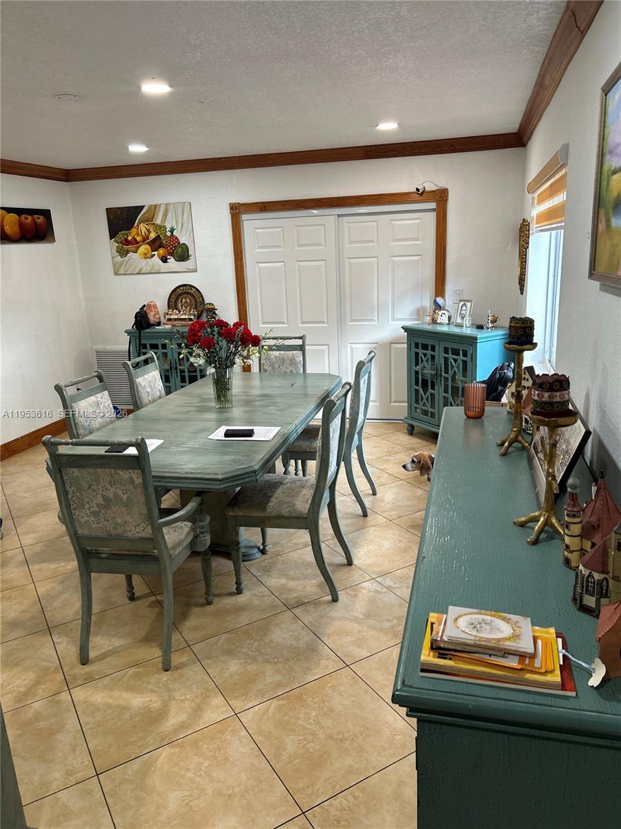 2600 Southwest 126th Avenue Miami, FL 33175 - Photo 6 of 23 a view of a dining room with furniture and a potted plant