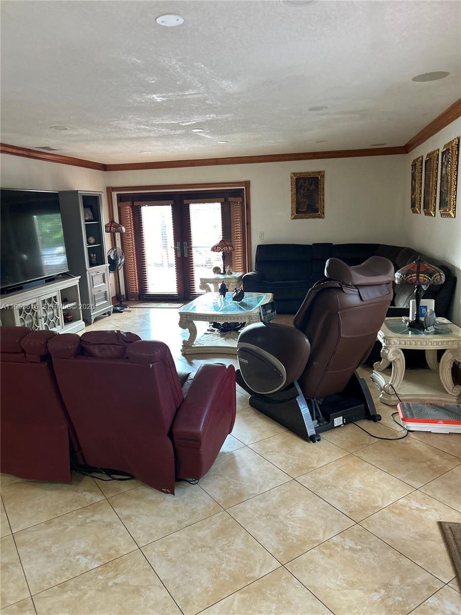 2600 Southwest 126th Avenue Miami, FL 33175 - Photo 10 of 23 a living room with furniture and a flat screen tv