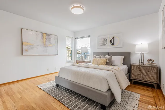 a bedroom with a bed and a painting on the wall