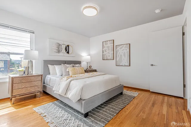 a bedroom with a bed and a night stand