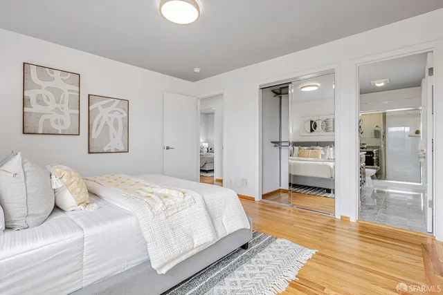 a spacious bedroom with a bed and a view of walk in closet