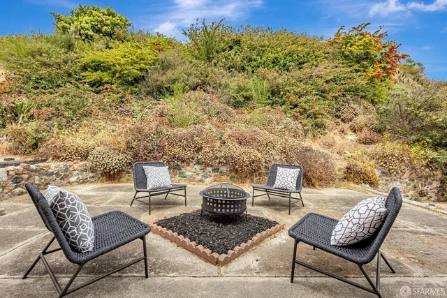 a view of a patio with couple of chairs