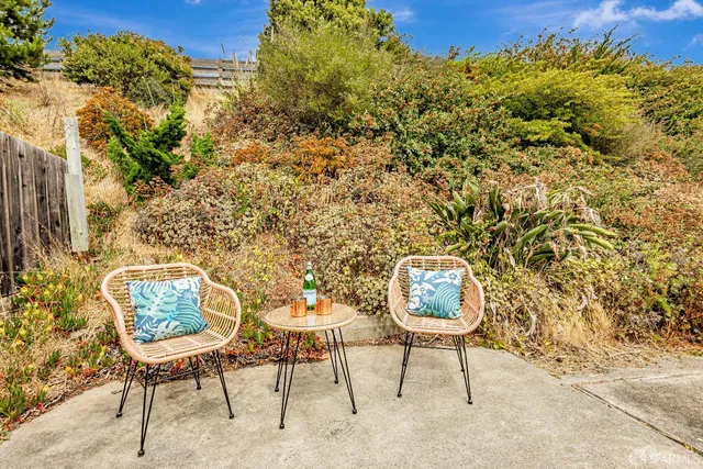 a balcony with chairs and a table