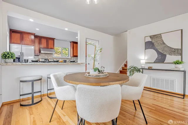 a dining room with furniture a window and wooden floor