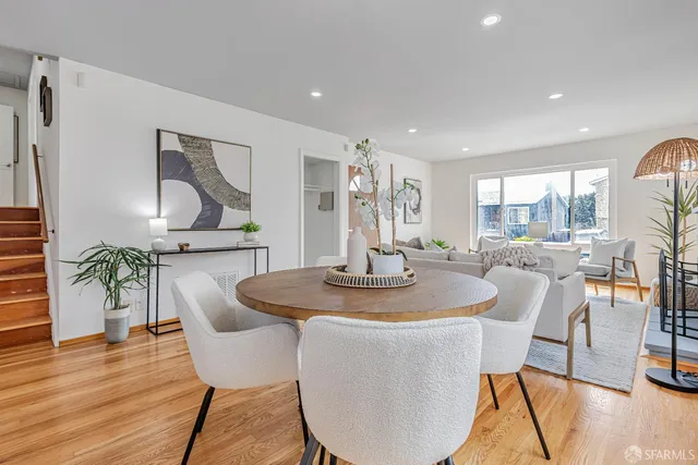 a dining room with furniture and wooden floor