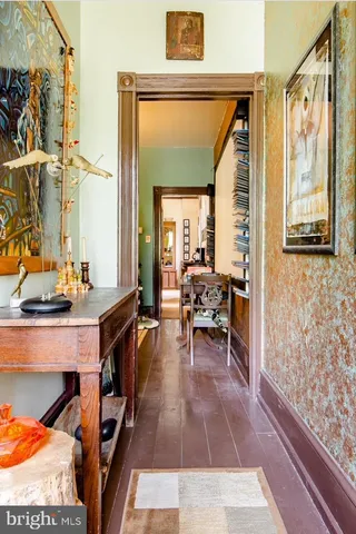 a living room with furniture and a painting on the wall