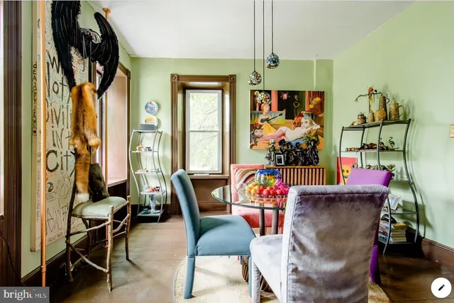 a view of a dining room with furniture and a window