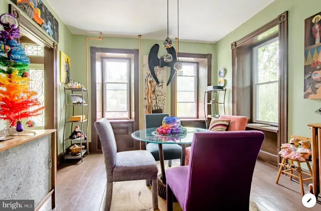 a dining room with furniture a chandelier and wooden floor