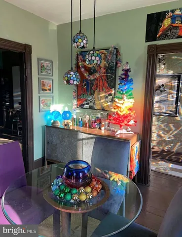 a room with painting on wall and a table