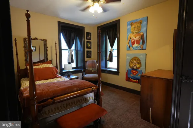 a bedroom with two beds and a chandelier