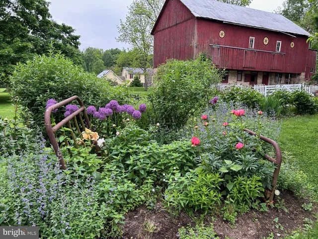 a view of a house with a yard and garden