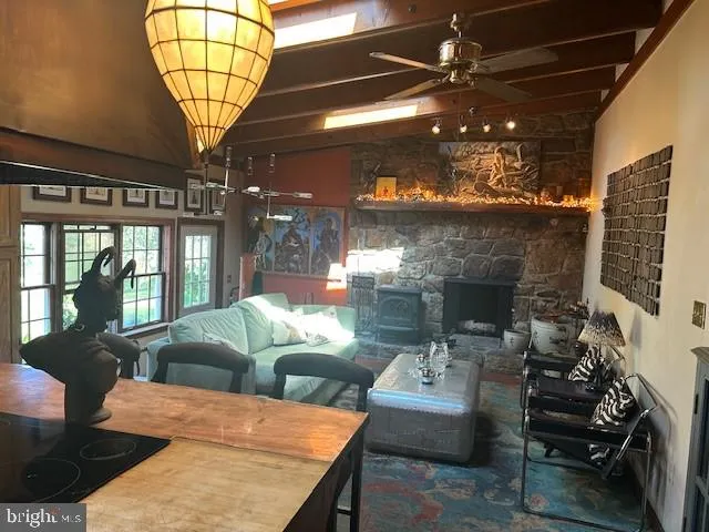 a living room with furniture a chandelier and a fireplace