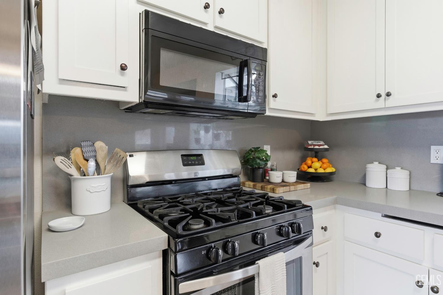 Undisclosed Address Tehachapi, CA 93561 - Photo 13 of 40 a kitchen with stainless steel appliances granite countertop a stove a microwave and cabinets