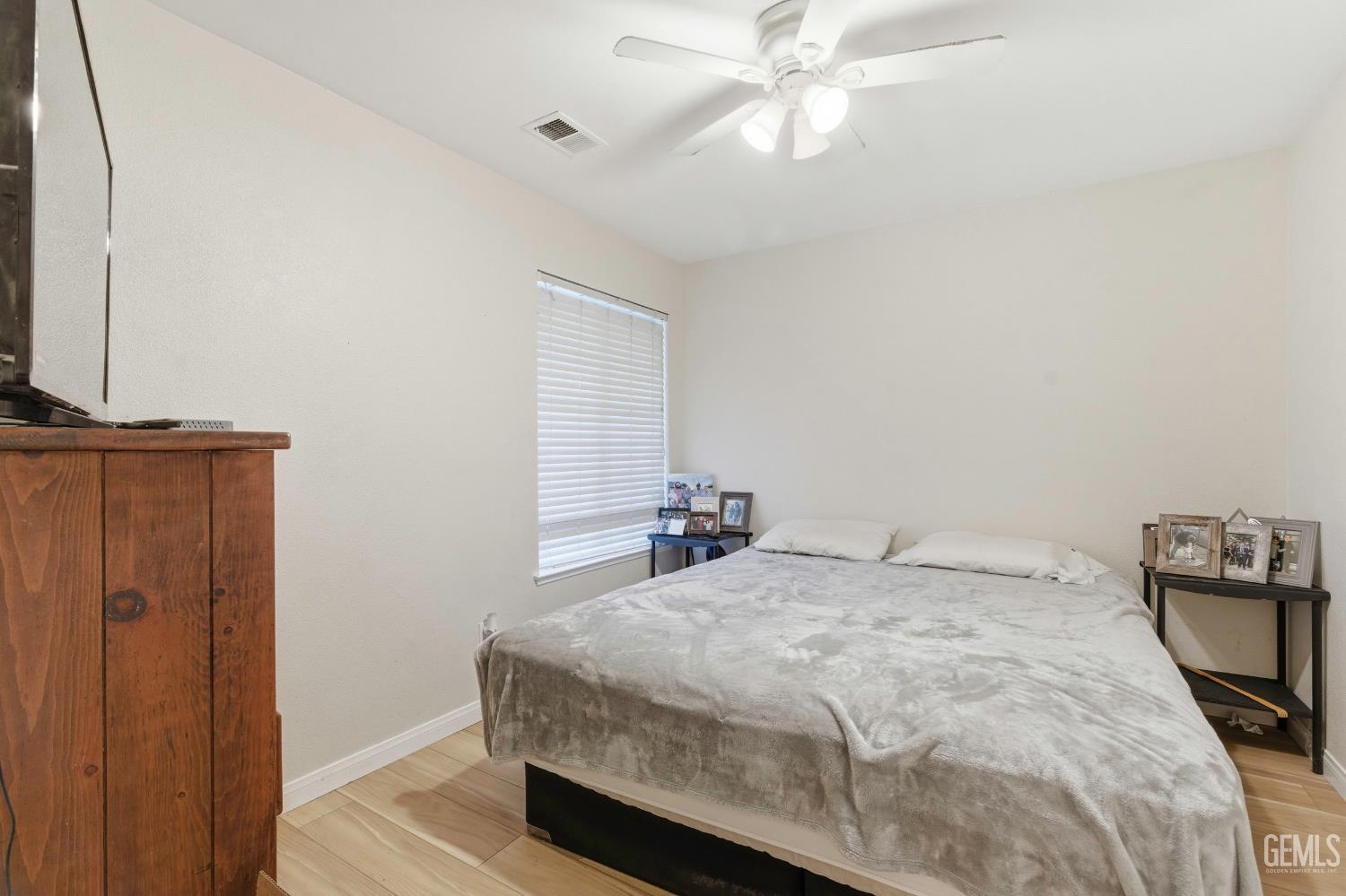 Undisclosed Address Tehachapi, CA 93561 - Photo 21 of 40 a bedroom with a bed and a chandelier