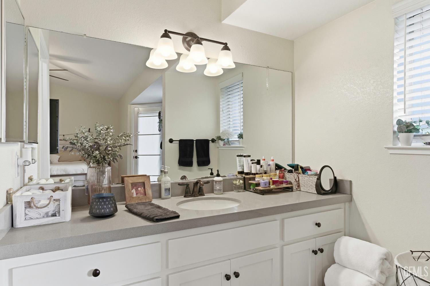 Undisclosed Address Tehachapi, CA 93561 - Photo 28 of 40 a bathroom with a toilet a sink and mirror