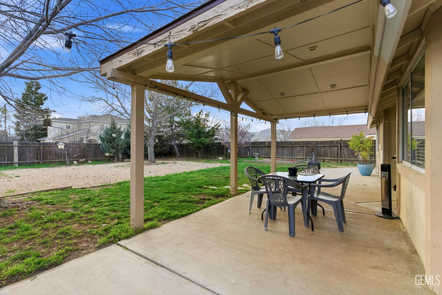 Undisclosed Address Tehachapi, CA 93561 - Photo 34 of 40 a view of a patio with table and chairs under an umbrella