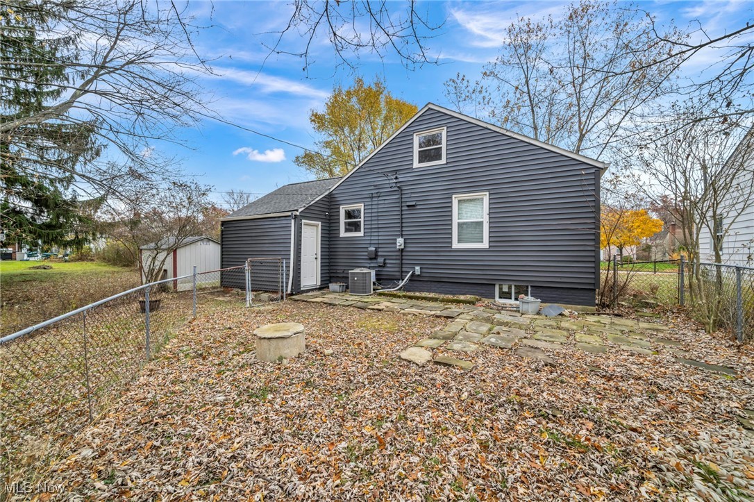 1682 Overbrook Road Lyndhurst, OH 44124 - Photo 28 of 33 Back of property featuring a fenced backyard, a patio area, and a storage shed