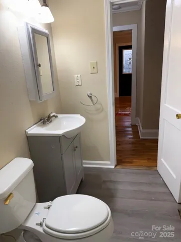 a white toilet sitting next to a bathroom sink