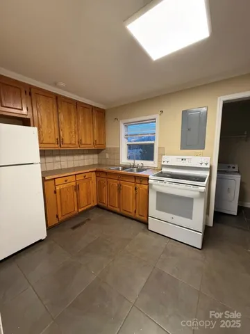 a kitchen with cabinets stainless steel appliances and a sink