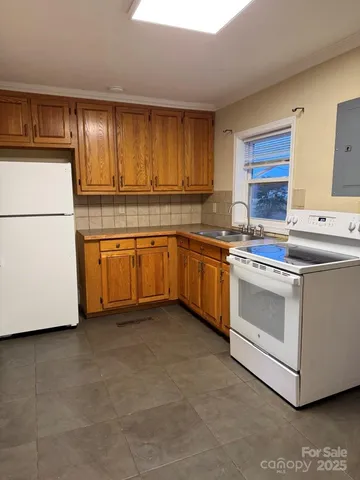 a kitchen that has a sink and a stove in it