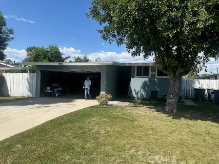 a view of a house with a yard and garage