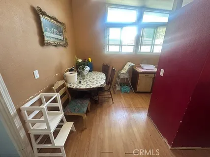 a living room with furniture a window and wooden floor