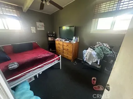 a bed room with a bed and a tv