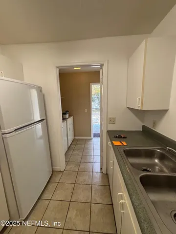 a kitchen with a sink and a refrigerator