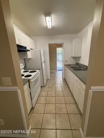 a kitchen with a sink a refrigerator a stove a washer and dryer