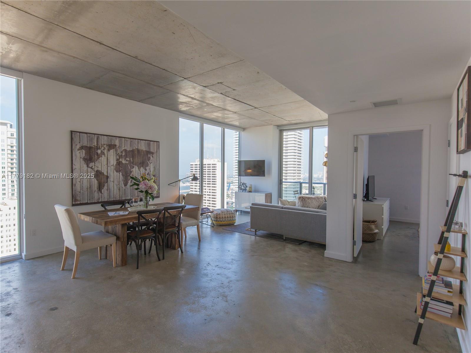 151 Southeast 1st Street, Unit 2802 Miami, FL 33131 - Photo 17 of 19 a dining room with furniture and wooden floor