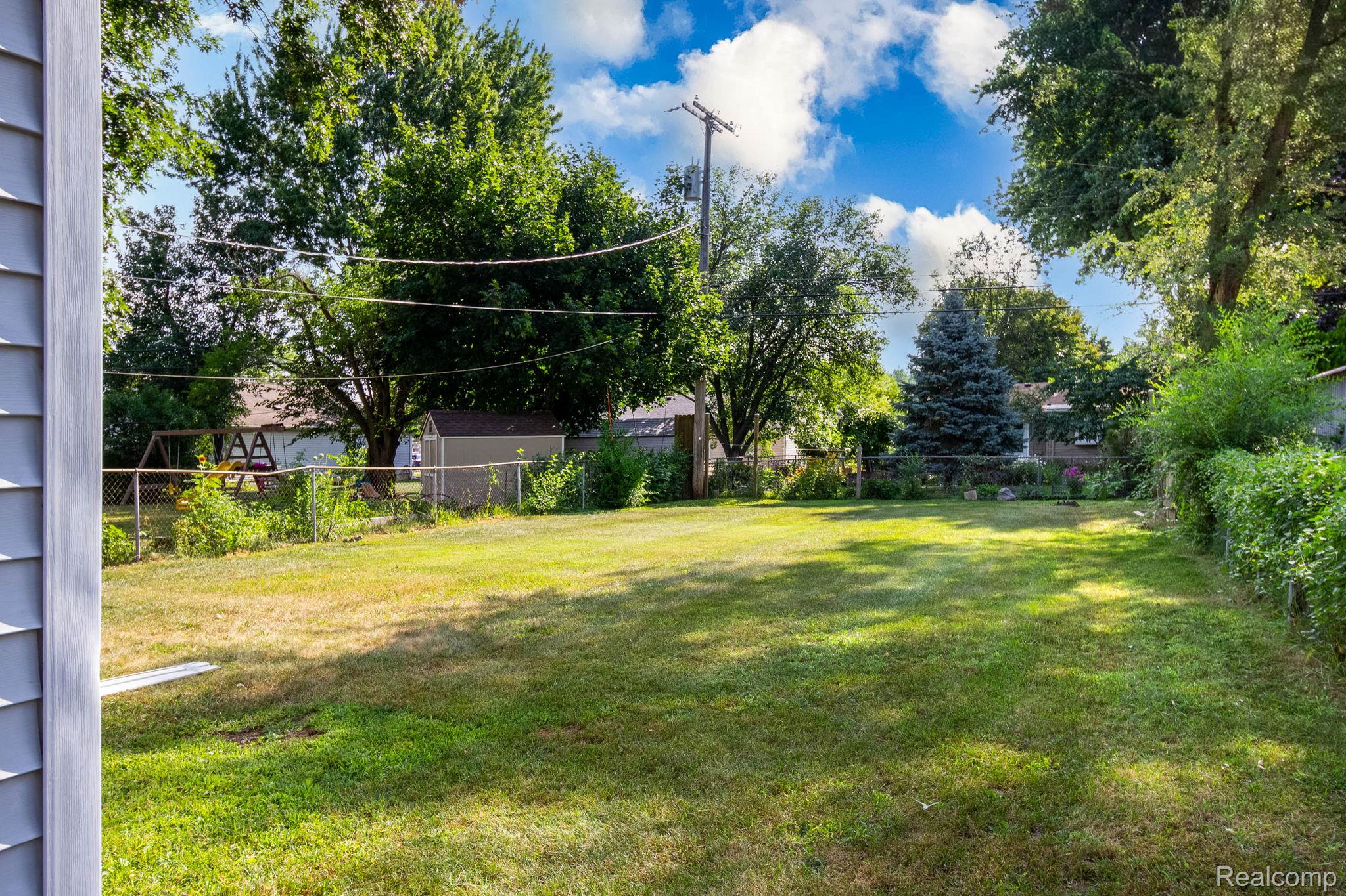 2559 Harrison Avenue Rochester, MI 48307 - Photo 25 of 32 Backyard, large lawn, mature trees