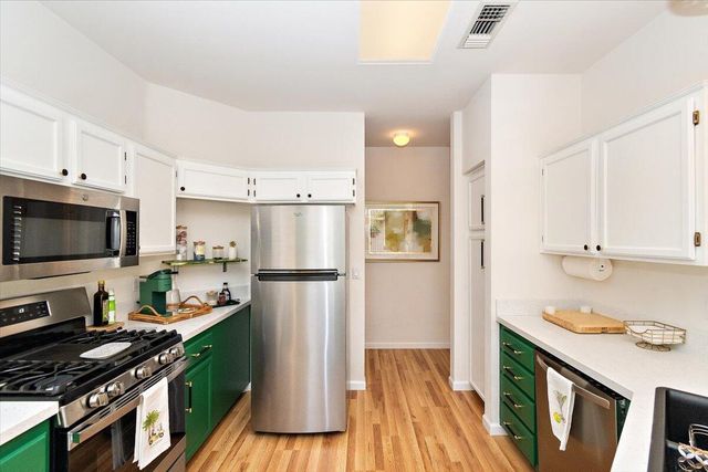 a kitchen with wooden cabinets and a stove top oven