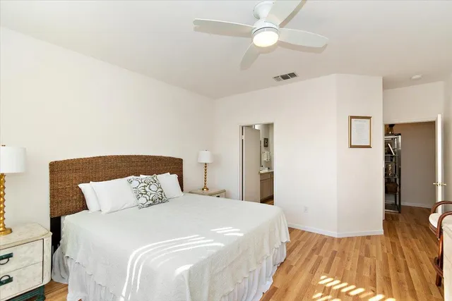 a bedroom with a bed and a wooden floor