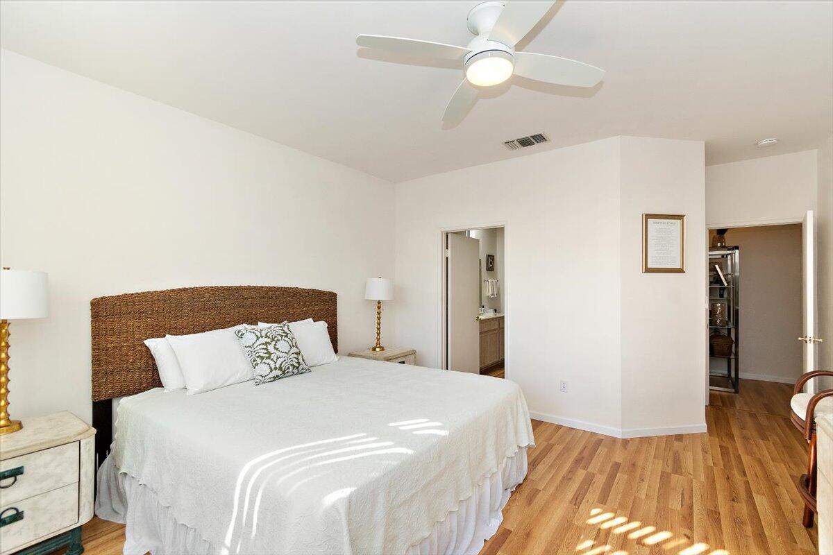 78995 Champagne Lane Palm Desert, CA 92211 - Photo 16 of 26 a bedroom with a bed and a wooden floor