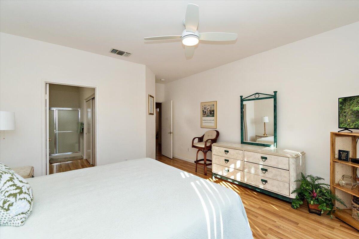 78995 Champagne Lane Palm Desert, CA 92211 - Photo 17 of 26 a bedroom with a bed and a chandelier