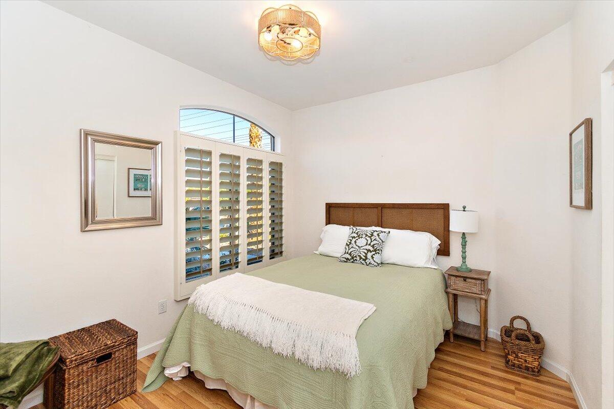 78995 Champagne Lane Palm Desert, CA 92211 - Photo 19 of 26 a bedroom with a bed and a chandelier