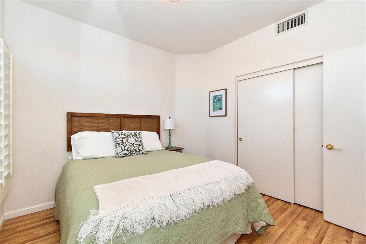 78995 Champagne Lane Palm Desert, CA 92211 - Photo 20 of 26 a bedroom with a bed and wooden floor