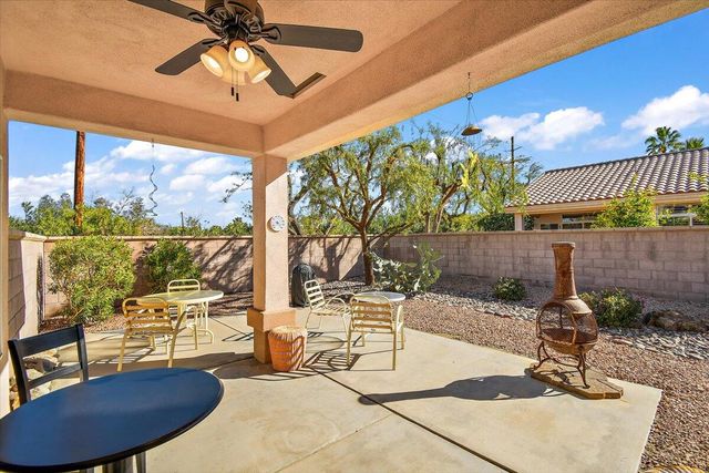 a building outdoor space with patio furniture and a potted plant