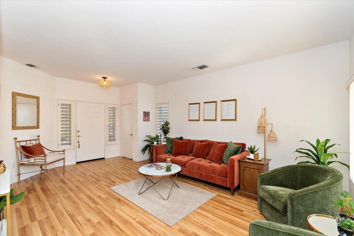78995 Champagne Lane Palm Desert, CA 92211 - Photo 5 of 26 a living room with furniture and wooden floor